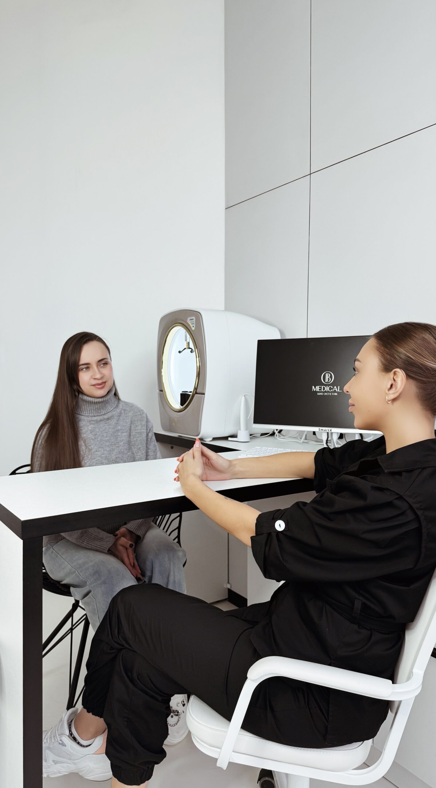 Врач-дерматолог разбирает с пациентом результаты 3D-диагностики кожи YANUS PRO в клинике в Мурманске